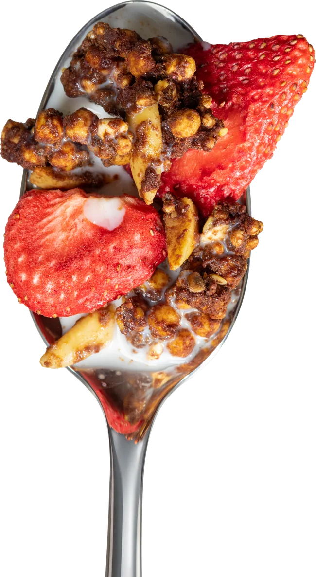 Strawberry Almond Chocolate granola with milk on a spoon